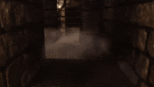 a dark room with a brick wall and a smoke coming out of it