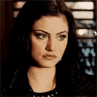 a close up of a woman 's face with a serious expression .