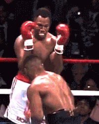 two boxers are fighting in a ring and one of them is wearing a shirt that says kc