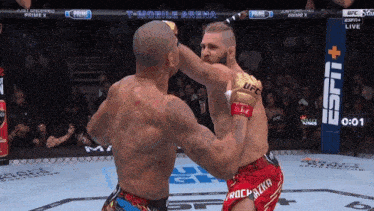two men are fighting in a boxing ring with a t-mobile arena banner in the background