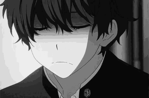 a black and white photo of a boy with his eyes closed and a sad look on his face .