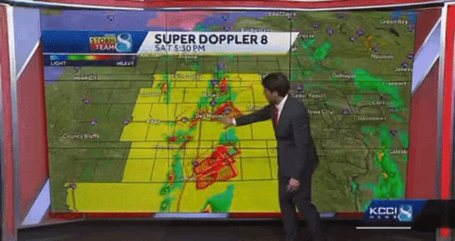 a man stands in front of a screen that says super doppler 8 on it