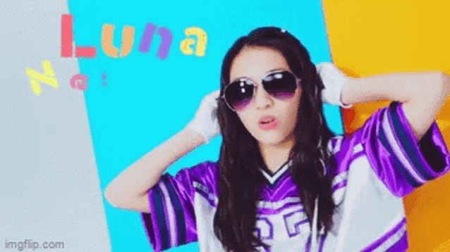 a girl wearing sunglasses and a purple shirt with the word luna on it .