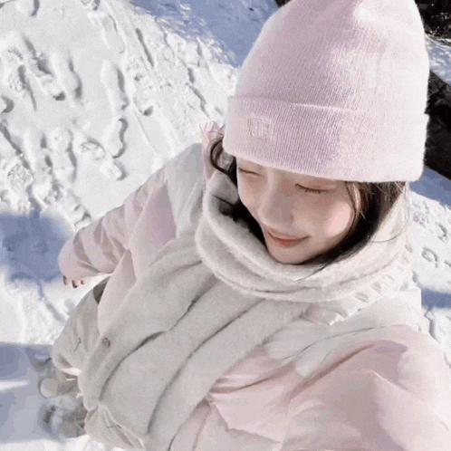 a girl wearing a pink beanie and a white scarf