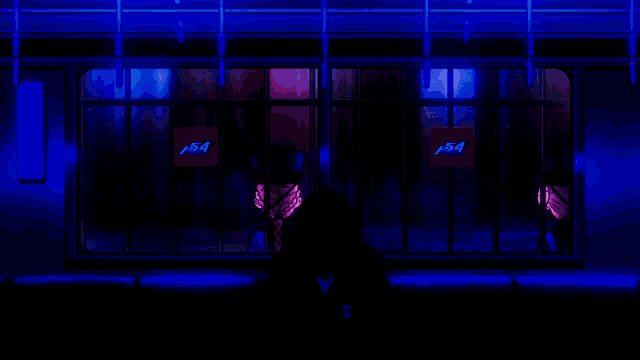 a man sitting in front of a window with a sign that says p54