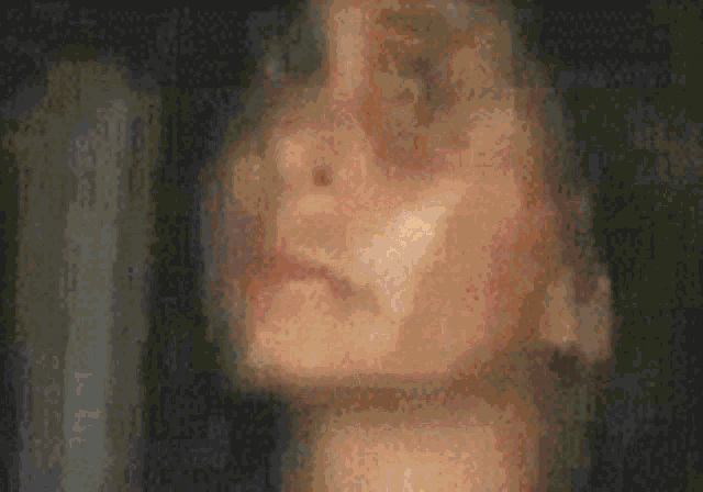 a blurry picture of a woman 's face with a blurred background .
