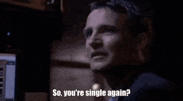 a man in a suit is looking at a computer screen and saying `` so you 're single again ? ''