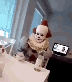 a person dressed as a clown is holding a bottle of wine .
