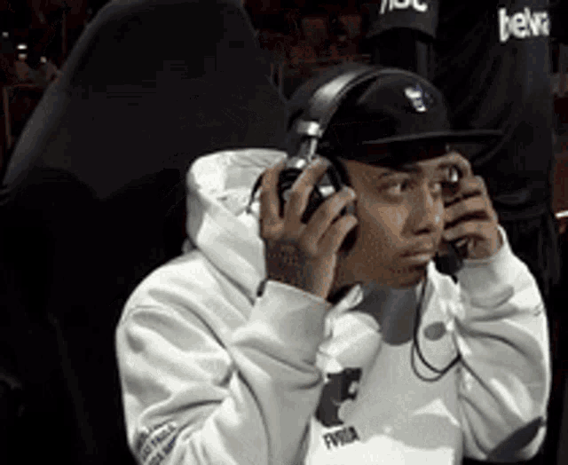 a man wearing headphones and a hat with the word bena on it