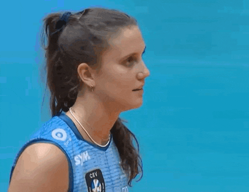 a female volleyball player wearing a blue jersey with the word cev on it