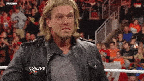 a man wearing a leather jacket that says wwe live