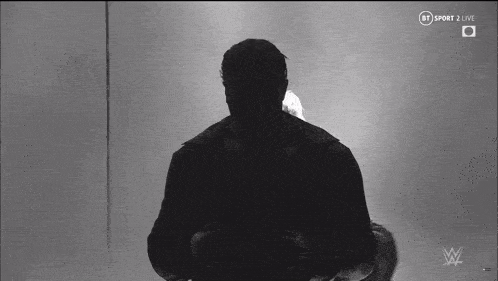 a silhouette of a man standing in front of a microphone with bt sport 2 live on the bottom