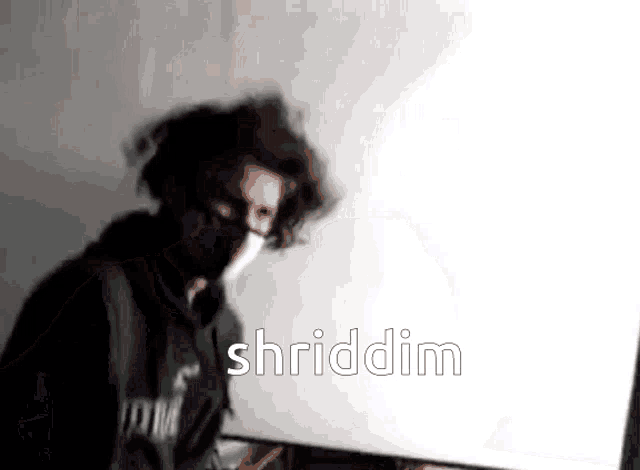 a man wearing a mask and a hoodie says shriddim