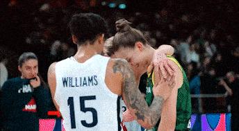 a basketball player with the number 15 on his jersey is hugging another player