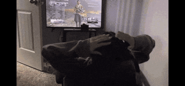 a person is playing a video game on a flat screen tv