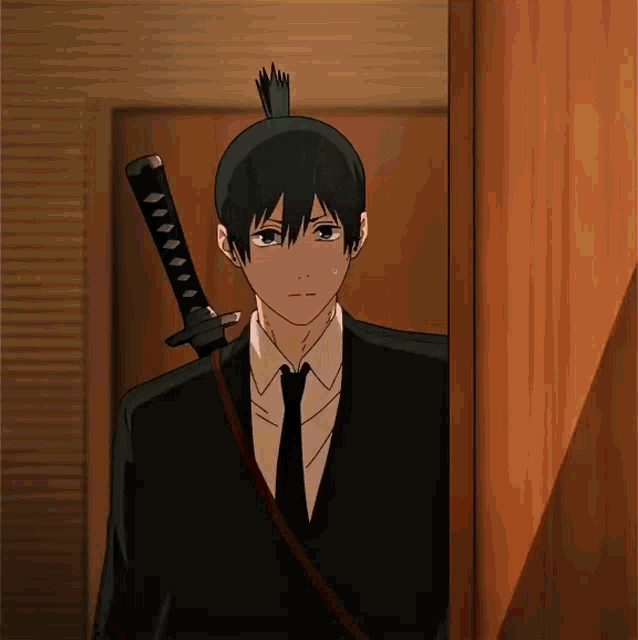 a man in a suit and tie is holding a sword