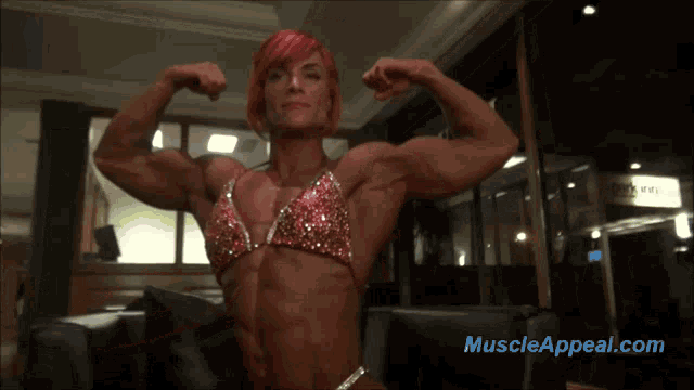 a woman is flexing her muscles in front of a muscle appeal.com logo