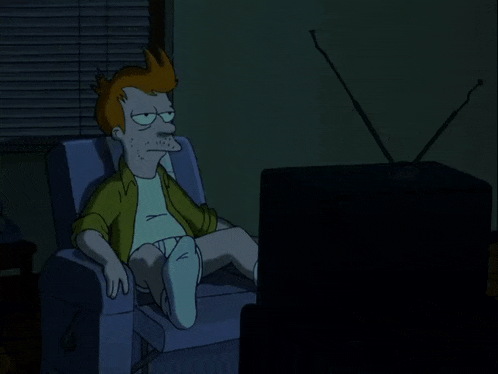 a cartoon character is sitting in a chair watching a television