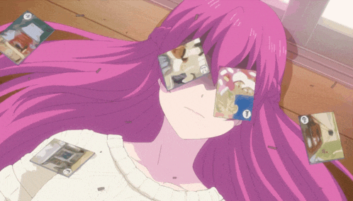 a girl with purple hair is laying on the floor with cards in front of her eyes including one that says ' a '