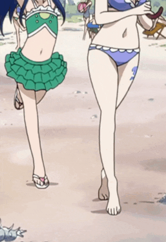 a couple of girls in bikinis are walking on a beach