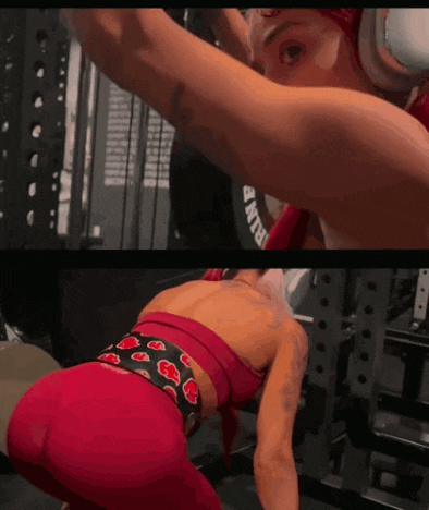 a woman in a red top is squatting down in front of a machine that says run on it