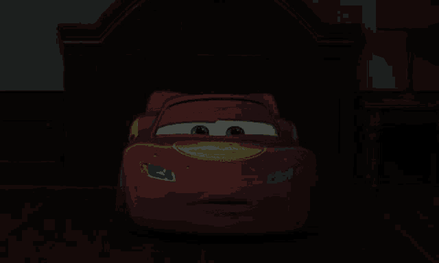 a lightning mcqueen car is sitting in the dark