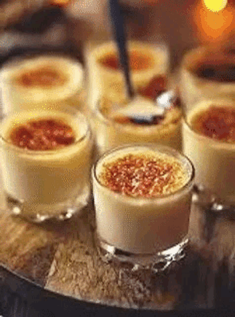 a close up of a tray of desserts with a spoon in them .