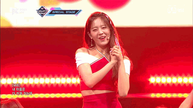 a woman in a red dress is on a stage with the words special stage below her