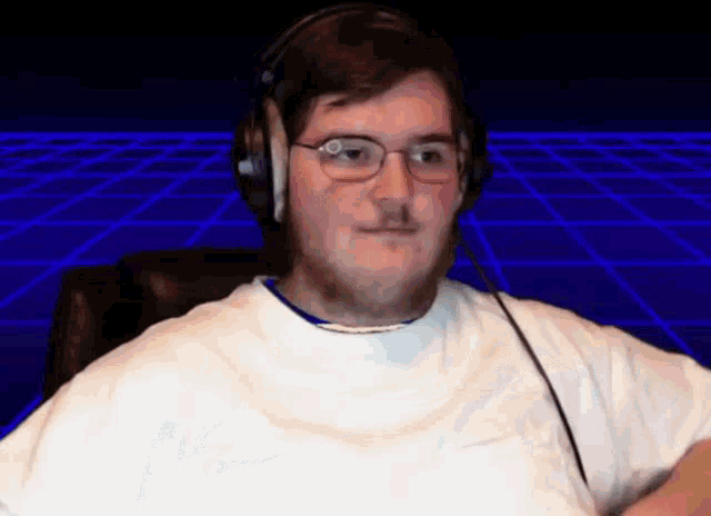 a man wearing headphones and glasses is sitting in front of a blue background