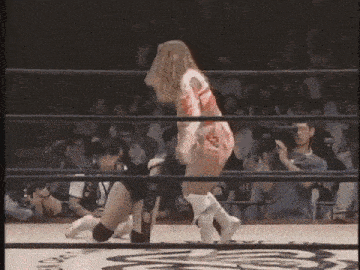 a woman in a wrestling ring with the letter s on her outfit