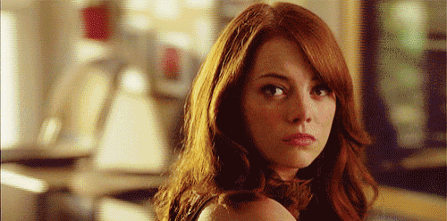 a close up of a woman 's face with red hair