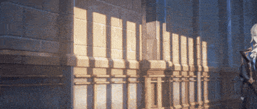 a woman stands in front of a brick wall with shadows cast on it