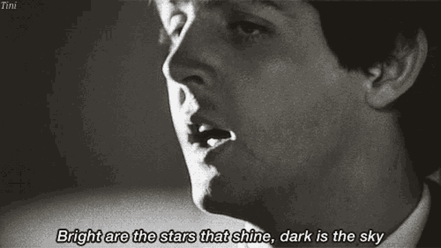 a black and white photo of a man with the words bright are the stars that shine dark is the sky below him