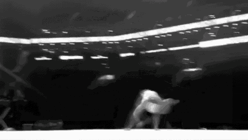 a black and white photo of a person doing a trick on a stage