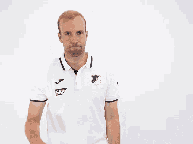 a man wearing a white shirt with sap on it
