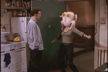 a woman wearing a turkey head and sunglasses is dancing in a kitchen .