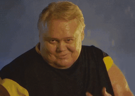 a man in a black shirt and yellow sleeves is making a funny face