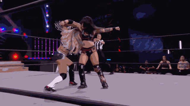 a woman in a wrestling ring is wearing knee pads with the letter n on them