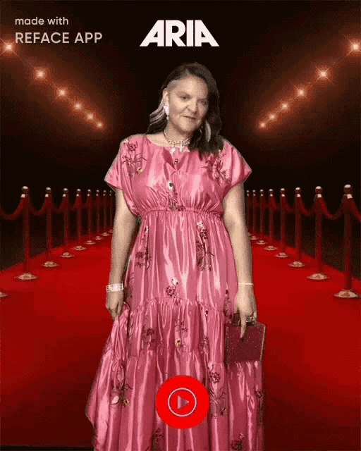 a woman in a pink dress is standing on a red carpet with aria written on the top