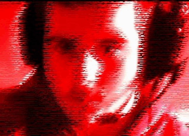 a close up of a person 's face on a red background