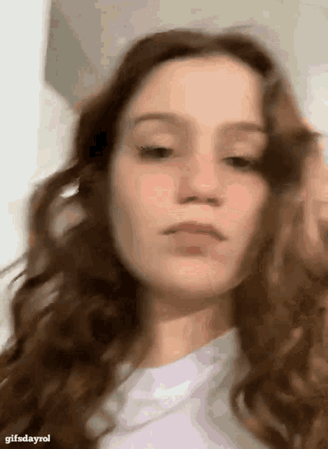 a close up of a woman 's face with her hair in the foreground .