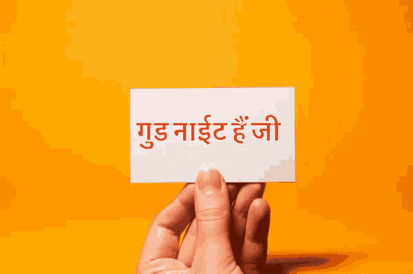 a person is holding a card that says good night