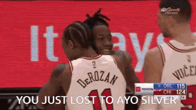 a group of basketball players are hugging each other and one of them says " you just lost to ayo silver "