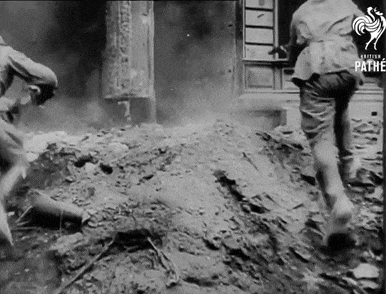 a black and white photo of a man running with the word pathe in the corner