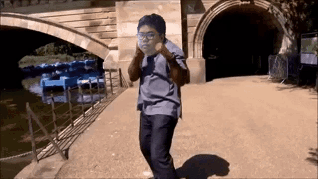 a man with a mask on his face is walking in front of a tunnel