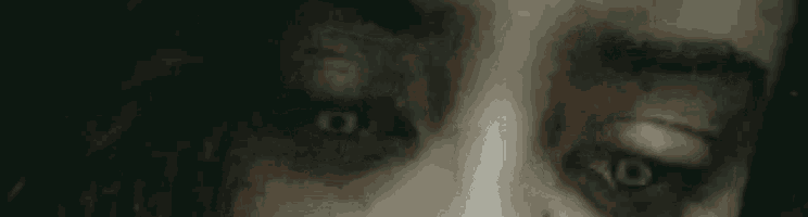 a close up of a woman 's eyes with blood on them
