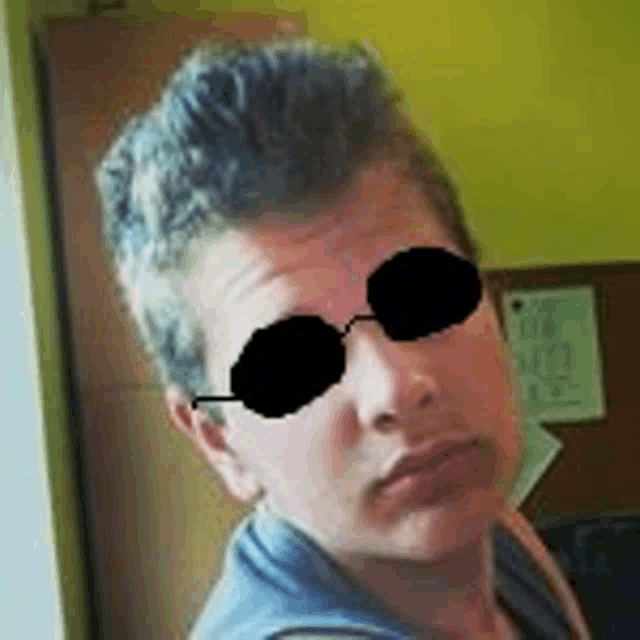 a close up of a person wearing sunglasses and a mohawk .