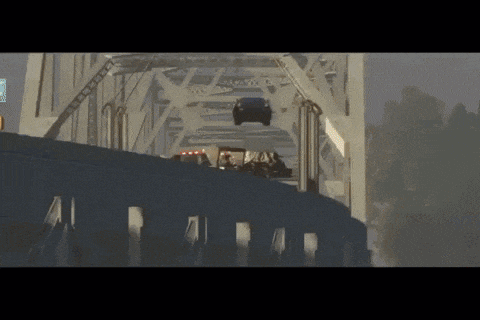 a car is flying over a bridge with a sign that says ' ambulance '