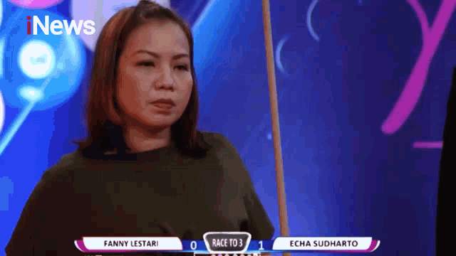 a woman is standing in front of a screen that says news