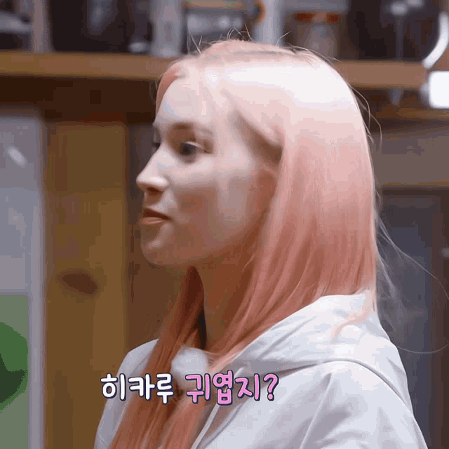 a woman with pink hair is wearing a white jacket with a sticker that says ' ? ' on it